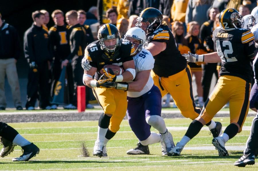 Iowa running back Mark Weisman carries in the first half. Weisman had three first-half touchdowns as the Hawkeyes raced out to a 38-7 lead over Northwestern.