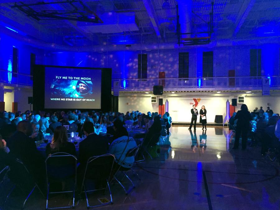 Attendees and organizers participate in a live auction at the McGaw YMCA on Saturday. The McGaw YMCA held a gala that recognized a foundation and NU professor for their contribution to Evanston youth.
