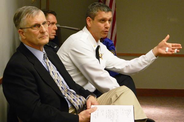 Then-Evanston police Cmdr. Jay Parrott (right), who is now the Deputy Police Chief, talks to residents at a 2013 community meeting. Police Chief Richard Eddington (left) is asking City Council on Monday to fund police body cameras.