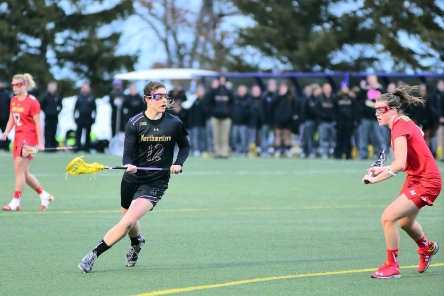 Kaleigh Craig probes around a defender. The junior scored 3 times to help Northwestern reach its highest goal total of the season.