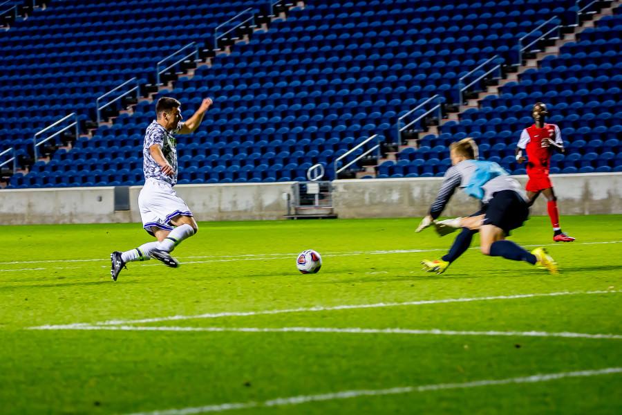 A Wildcat sprints for a ball in the box. NU was unable to create chances similar to this in its 2-0 loss at Loyola.