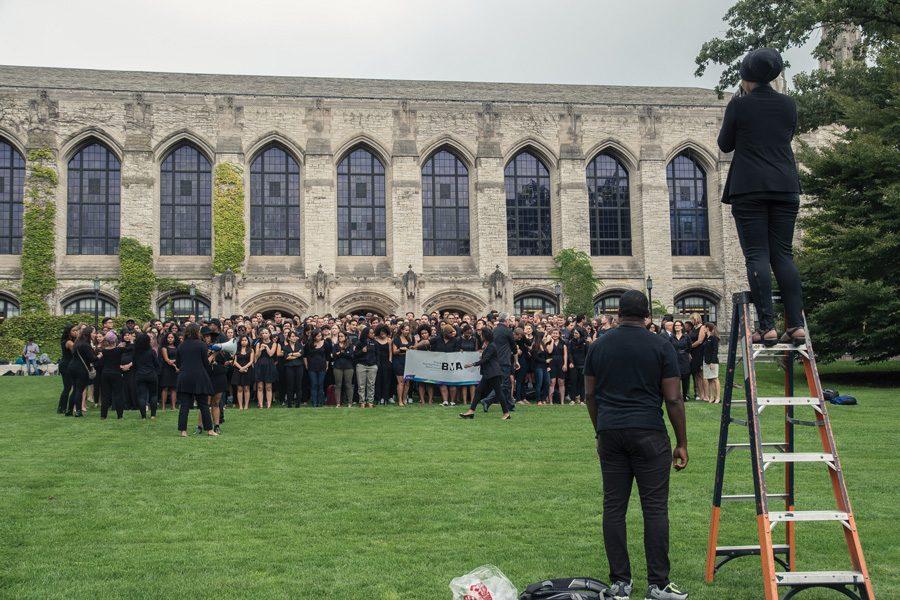 Kellogg students, faculty and administration gather for a group photo to express solidarity with protests against police killings. More than 350 people gathered on Deering Meadow on Friday for the photo.

