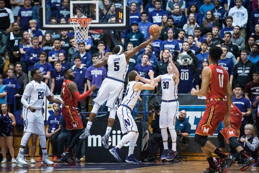 Dererk Pardon reaches out to grab a rebound. The sophomore center now has a key role as Northwestern’s starter in the middle.