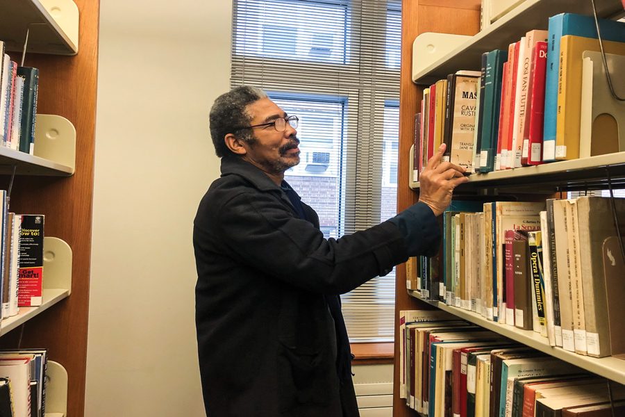 Evanston resident Sandy Horton reaches for a book at the Evanston Public Library. The city has a strong reading culture, and around 185 people signed up for a city-wide book club.  