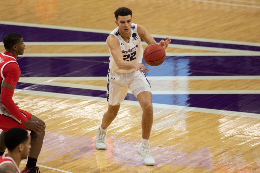 Pete Nance passes the ball. The junior forward scored a career-high 21 points against No. 10 Iowa.
