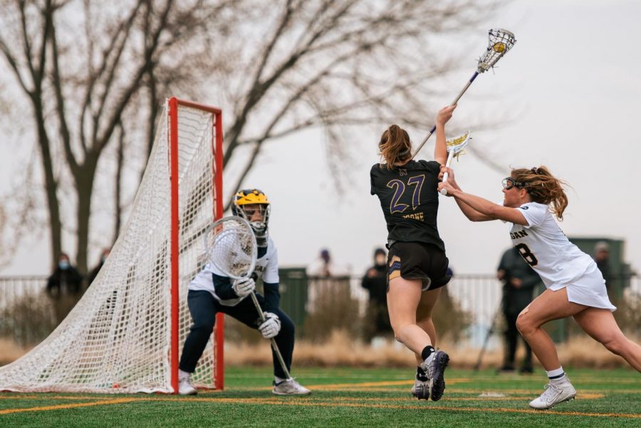 Lacrosse player Izzy Scanes with her lacrosse stick.