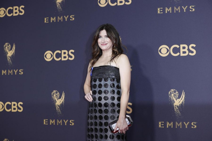 Actress and alumna Kathryn Hahn stands in a black polka-dot dress in front of a navy background with words “Emmys” and “CBS” in gold.