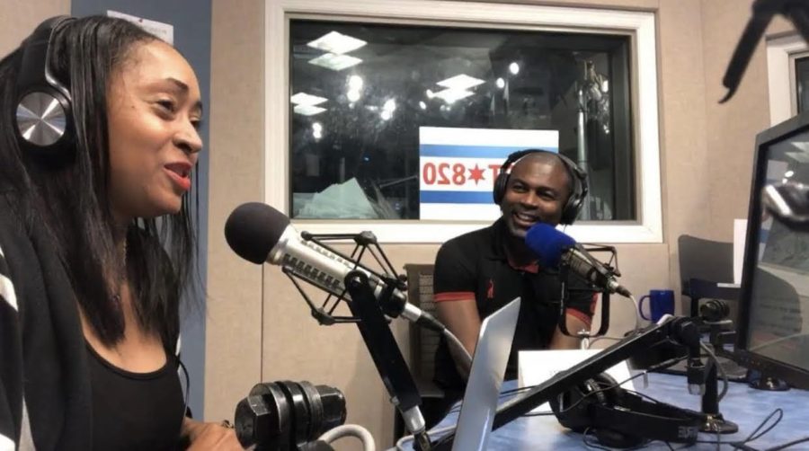Meleika Gardner and Rep. La Shawn K. Ford, both dressed in black t-shirts with over-ear headphones on, chat into microphones in a recording studio with tan walls.