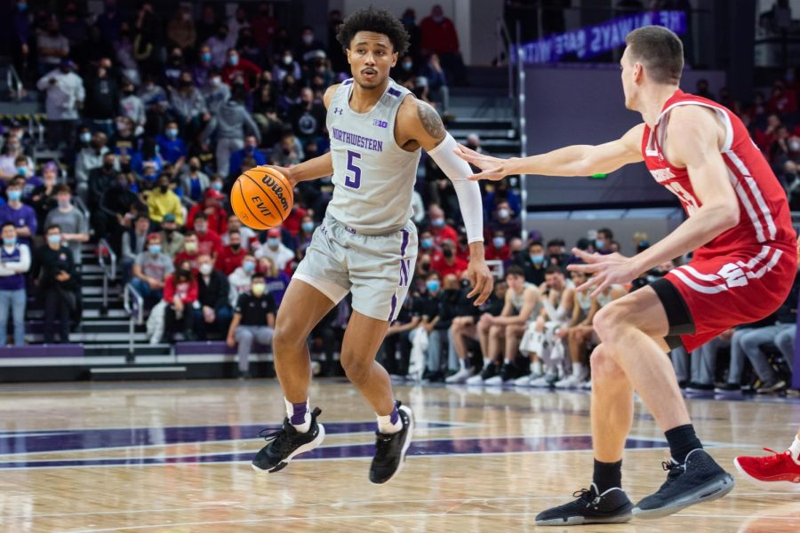 Basketball player in gray dribbles the ball