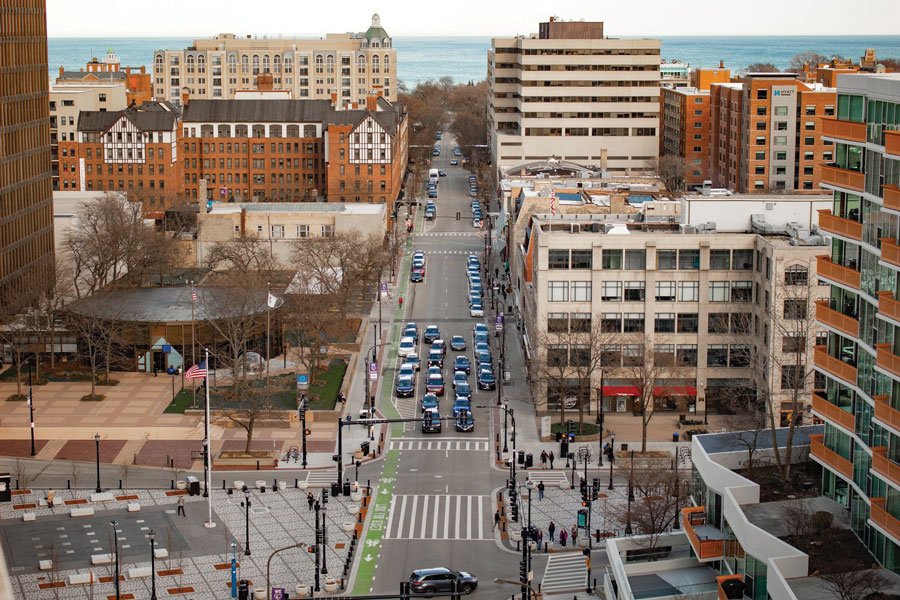 An overhead shot of the city with orange and white buildings on each side.