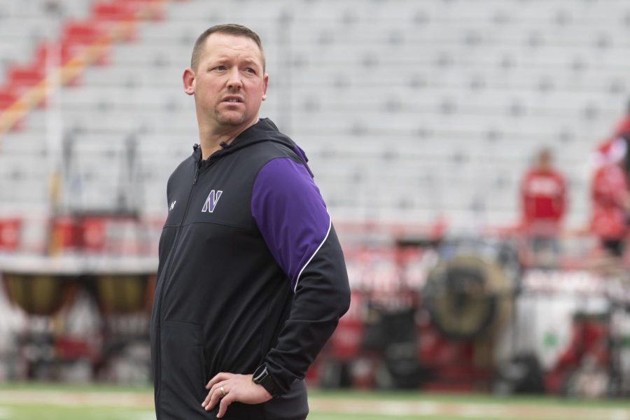 A coach stands on the field.