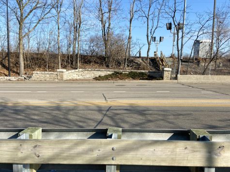 An embankment rises above a road.