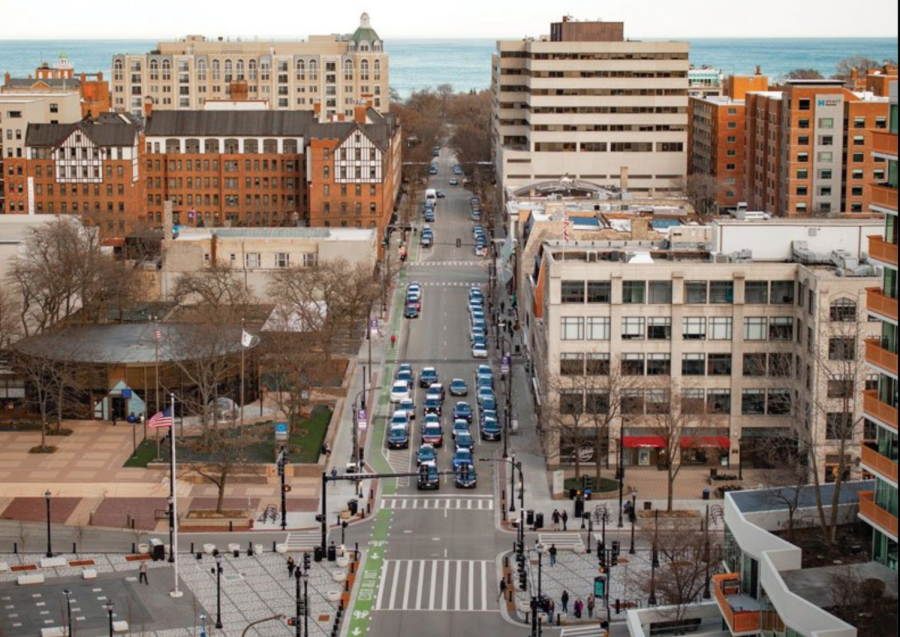 A picture of cars in a street framed by two buildings