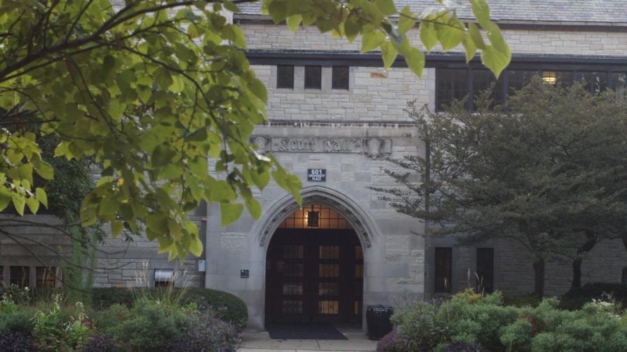 A gray building made of stone with the words “Scott Hall” engraved on top.