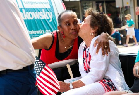 A woman kisses a spectator's cheek.