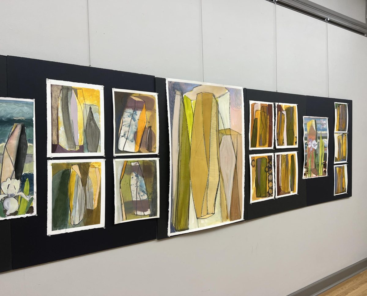 Alice George’s collection “Speculative Architecture,” based on David Rubman’s wooden towers, covers the walls of the Noyes Upstairs Gallery. 