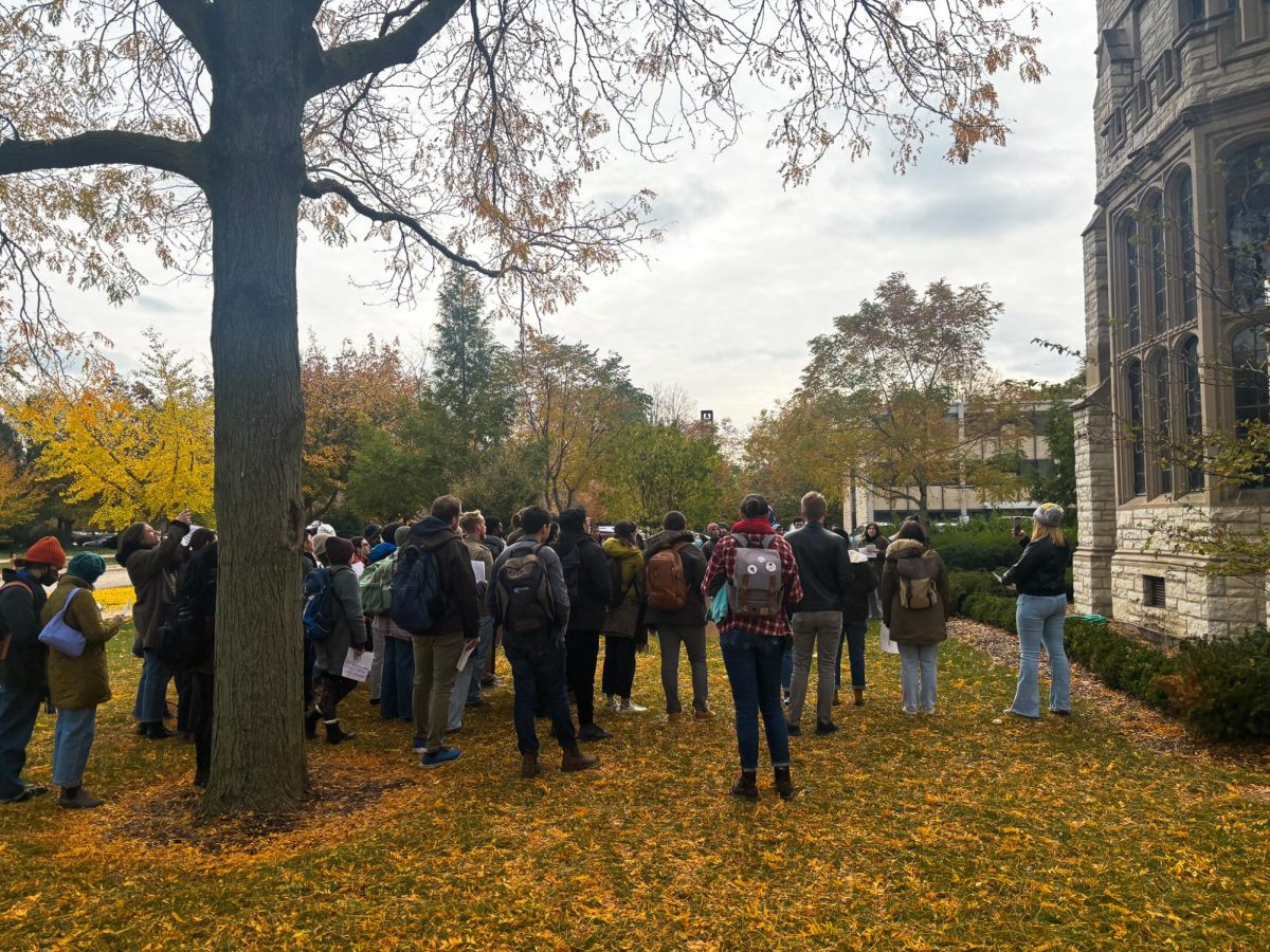 Community members rally outside TGS Commons Wednesday to express their support for NUGW’s demands.