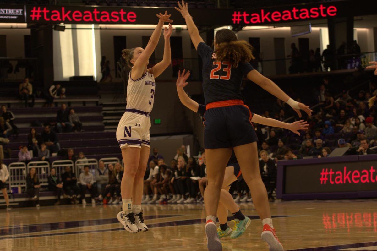 Graduate student guard Maggie Pina shoots a three-pointer.