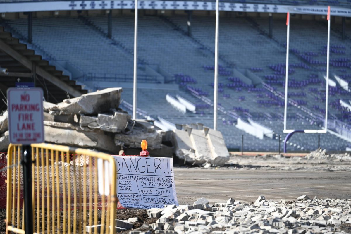A sign reading “Danger” in front of stadium bleachers.