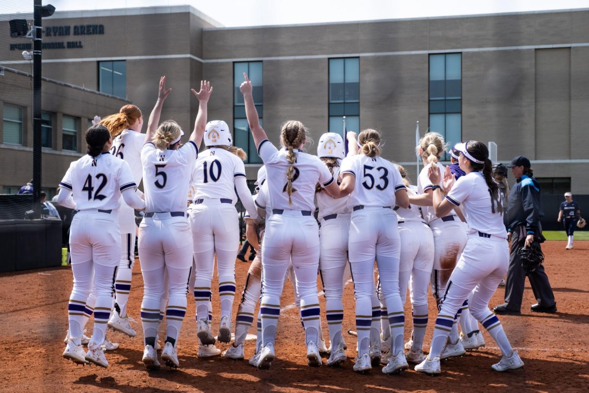 Northwestern celebrates at the plate after a home run.