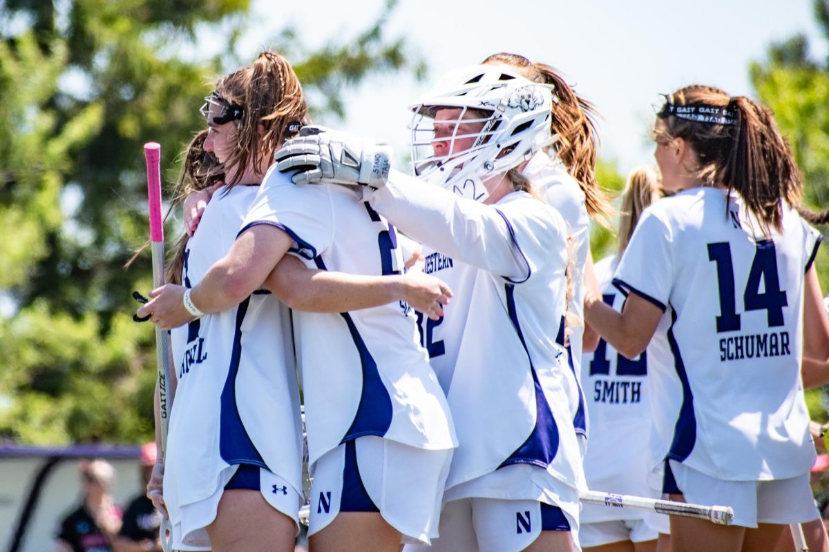 Graduate student attackers Izzy Scane and Erin Coykendall hug during their second-round victory over Denver. 