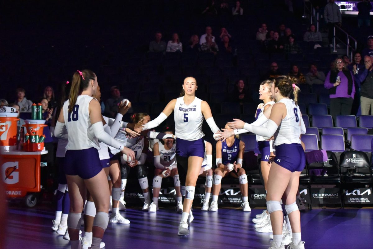 Volleyball players walk out together at the start of the game.