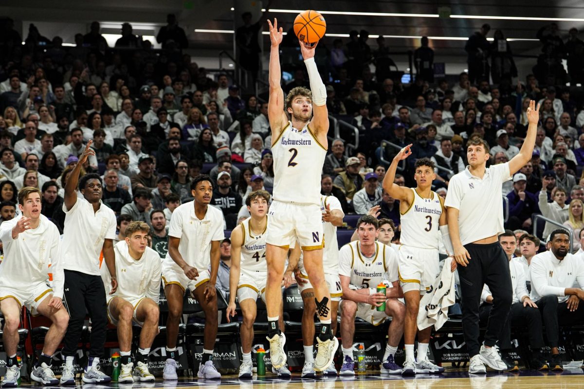 Junior forward Nick Martinelli attempts a three-pointer in Northwestern’s loss to No. 16 Michigan State Sunday. Martinelli had a team-high 27 points in the loss. 