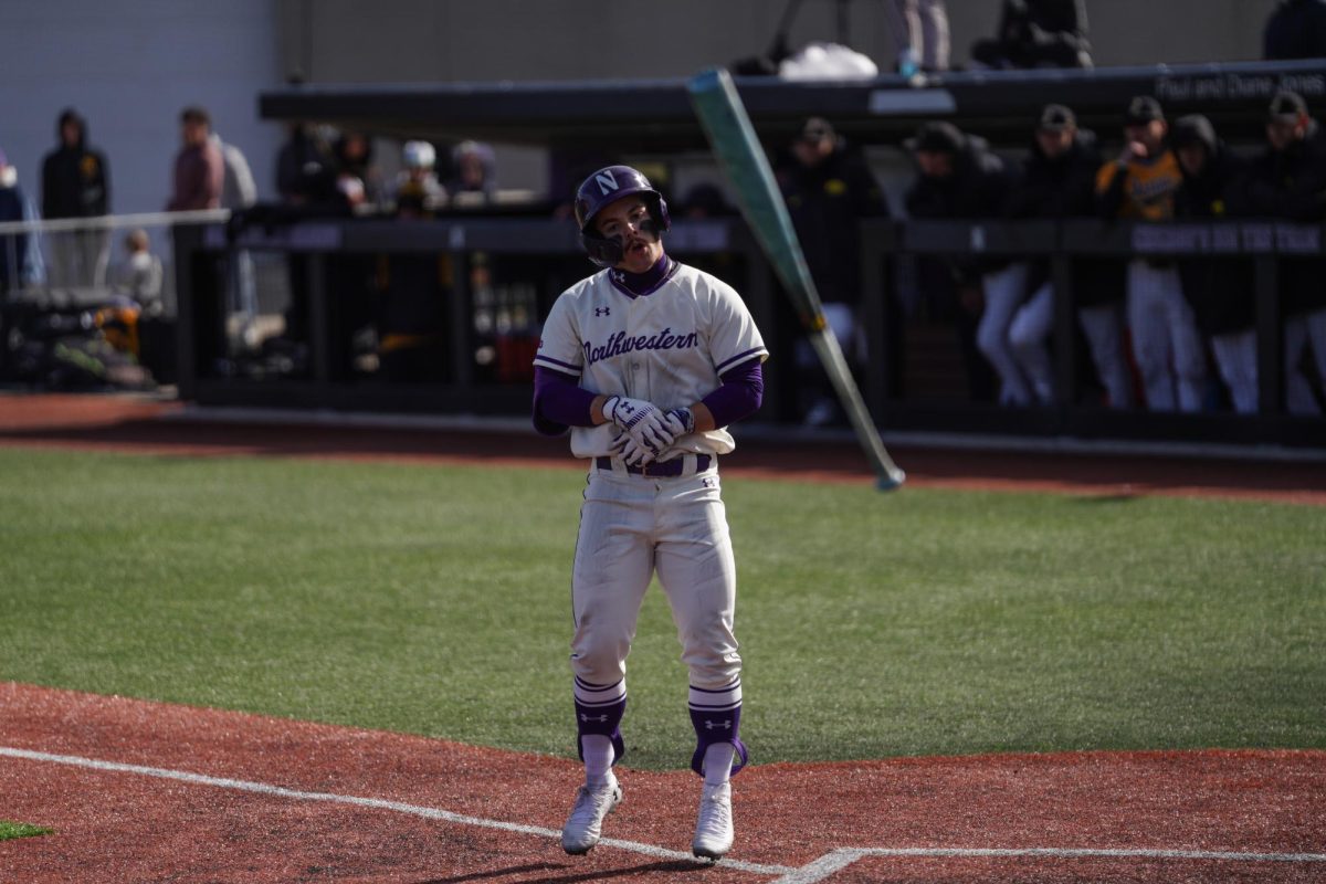 A player throws his bat to the ground in celebration after earning a walk.
