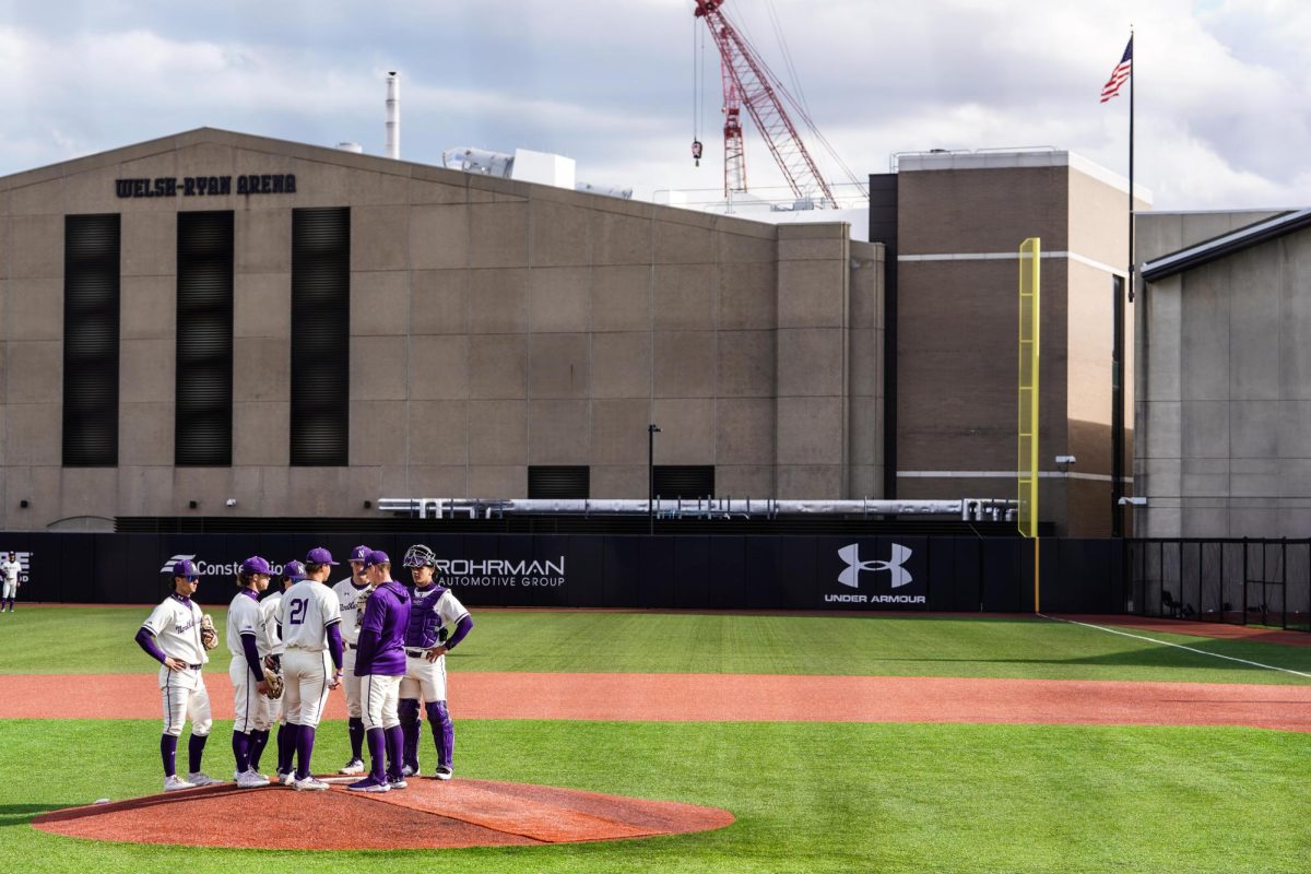 Northwestern players meet at the mound during a game earlier this season.