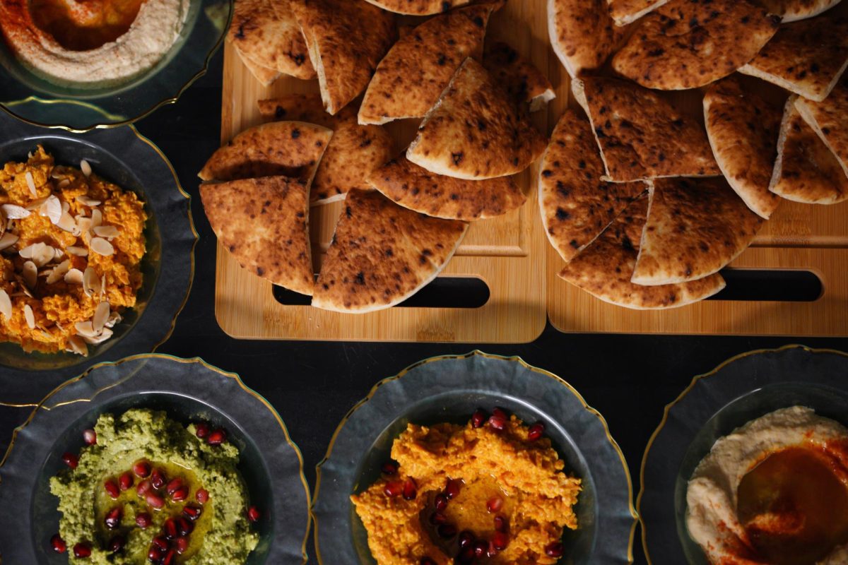 Flatbread slices and three different spreads.