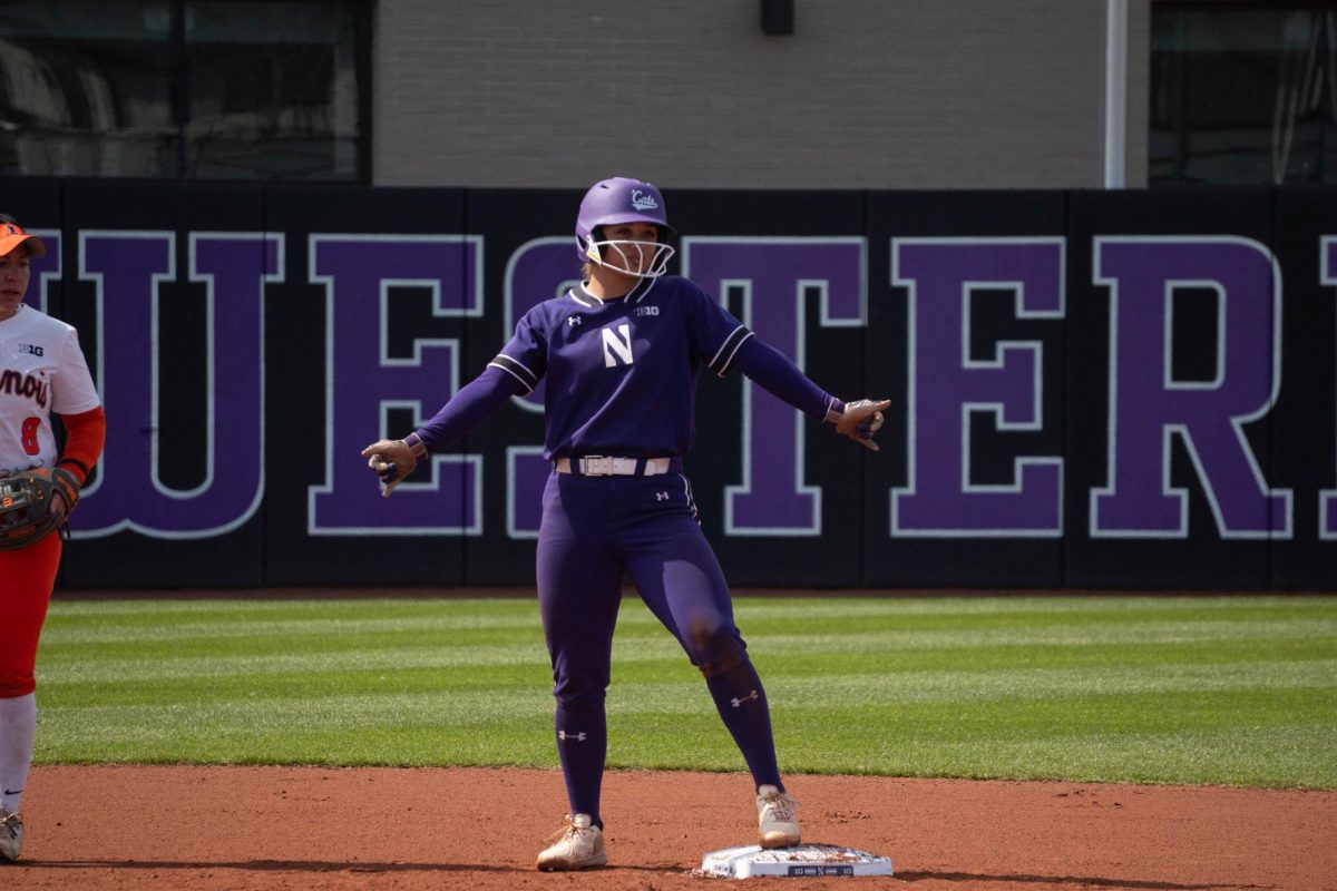 A player celebrates on a base after a hit.