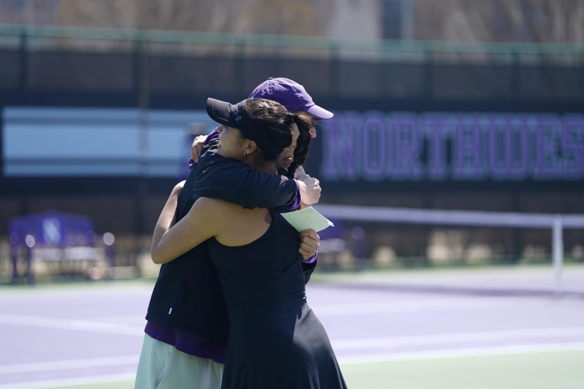 The coach and a player hug.