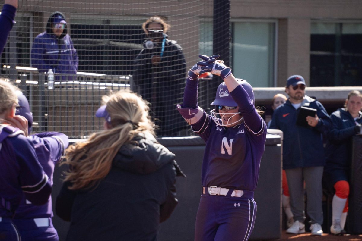 A player runs toward her team after a home run.