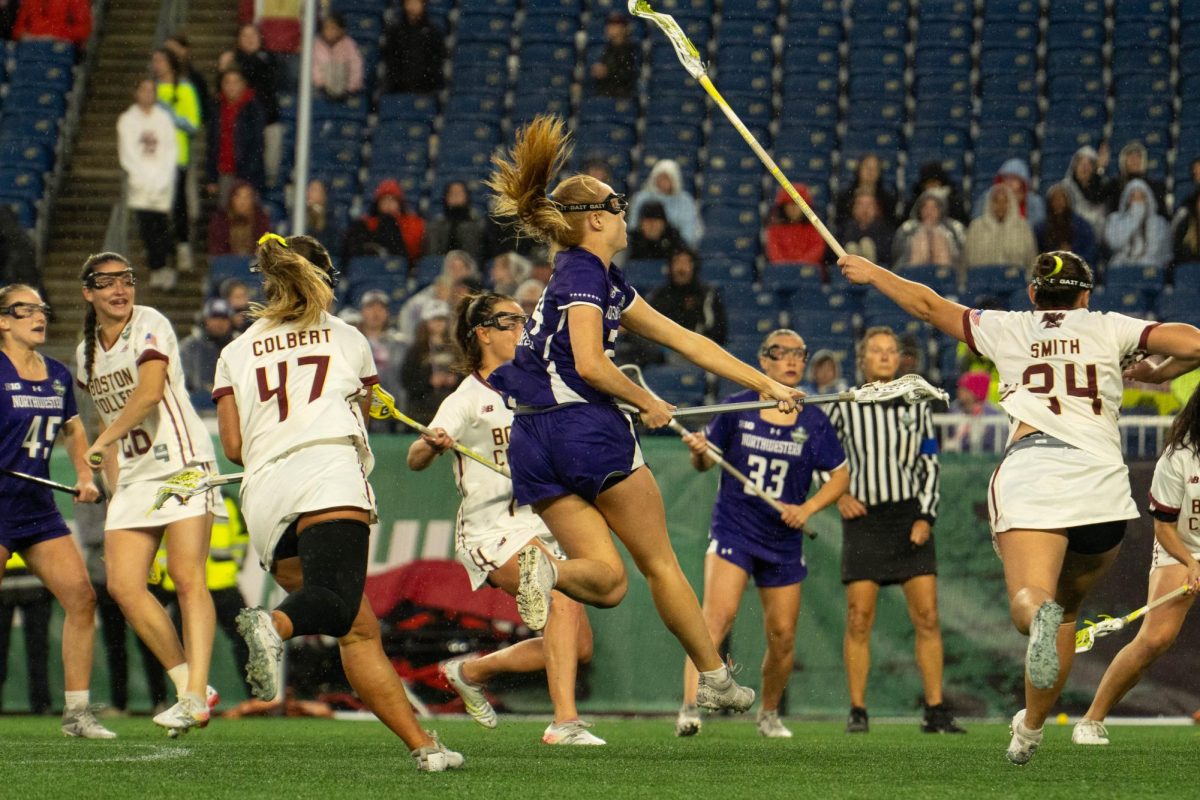 A player in a purple jersey jumps to shoot the ball. 