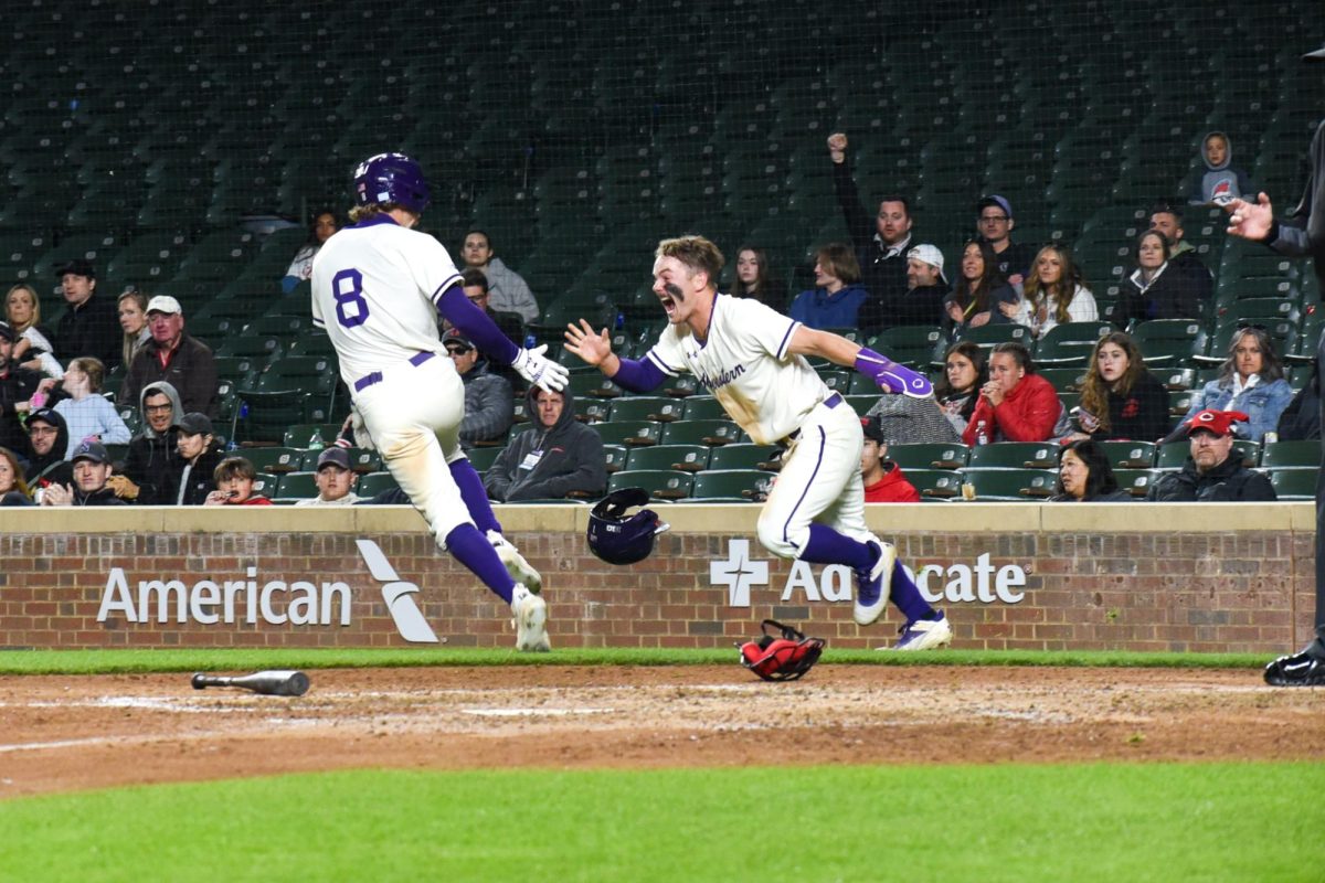Junior infielder Owen McElfatrick and senior outfielder Preston Knott celebrate Northwestern’s run-rule victory over Ohio State.