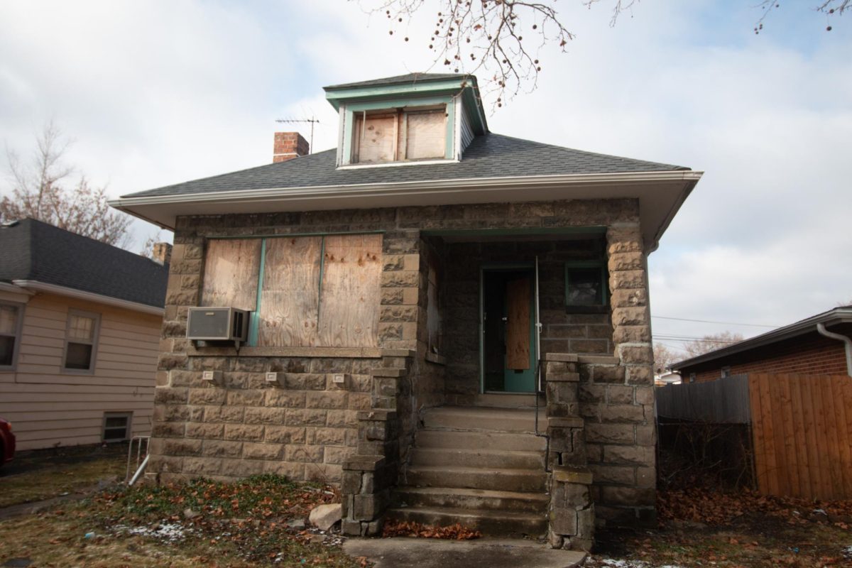 A wide shot depicts an abandoned home with boarded-up windows.
