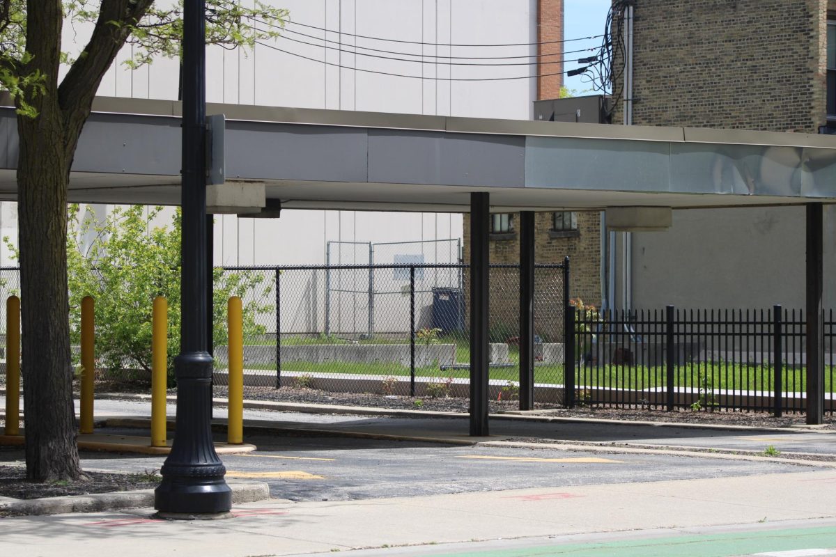 An old bank drive through sits next to a vacant lot.