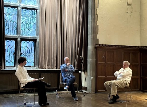 Professors Dean Karlan and Ian Kelly on the stage of the Great Room, accompanied by World Affairs Group President Santiago Elizondo.