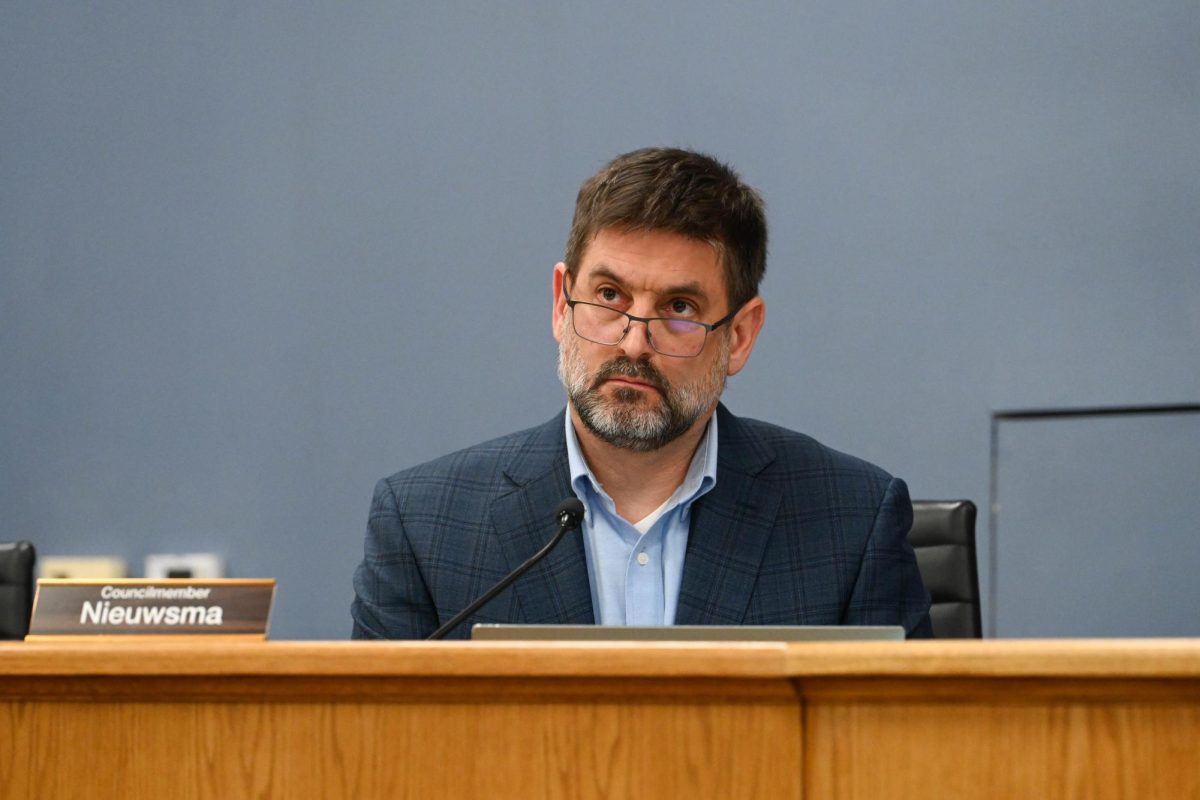 A man sits at a dais.