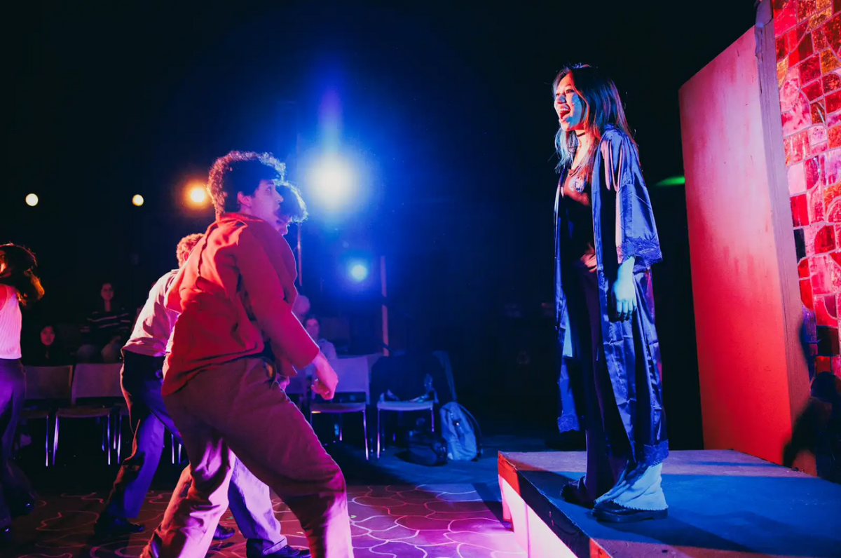 Gabby on stage with red lighting in Jesus Christ Superstar performance