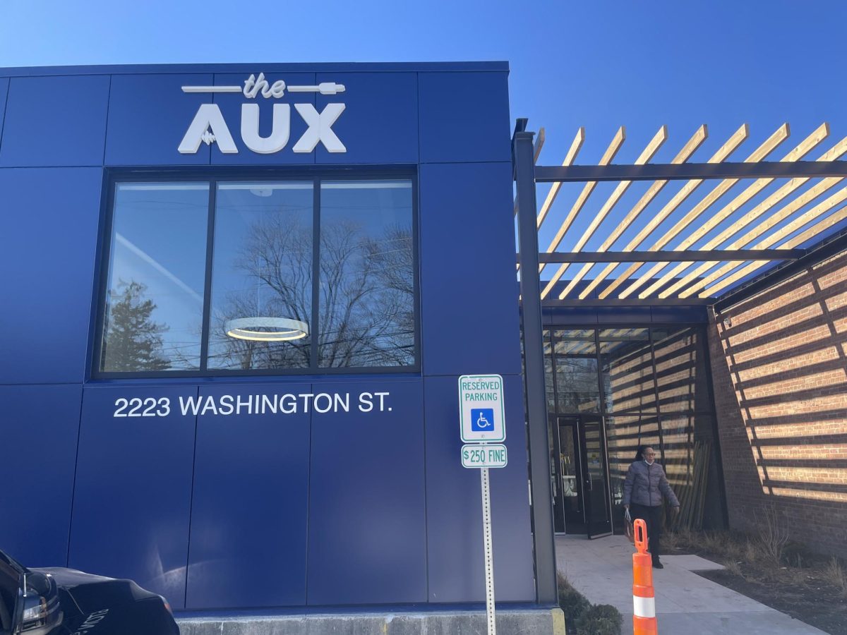 Blue building with “the Aux” sign on entrance