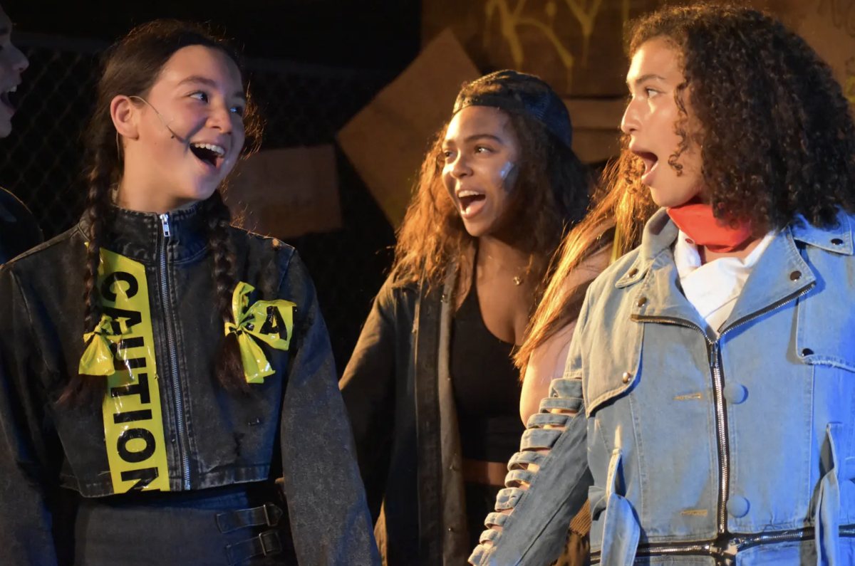Three actors sing in unison.