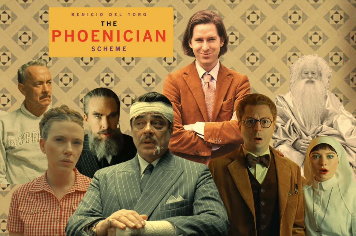 The cast of “The Phoenician Scheme” and Anderson stand under the words “The Phoenician Scheme.”